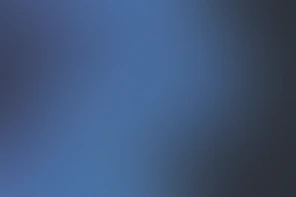 A smooth gradient shifting between deep blue and dark grey tones