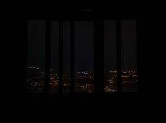 Evening cityscape viewed from Corpex Global’s office window, lights glowing warmly.