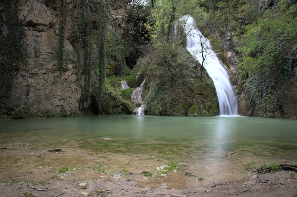 a waterfall over a body of water