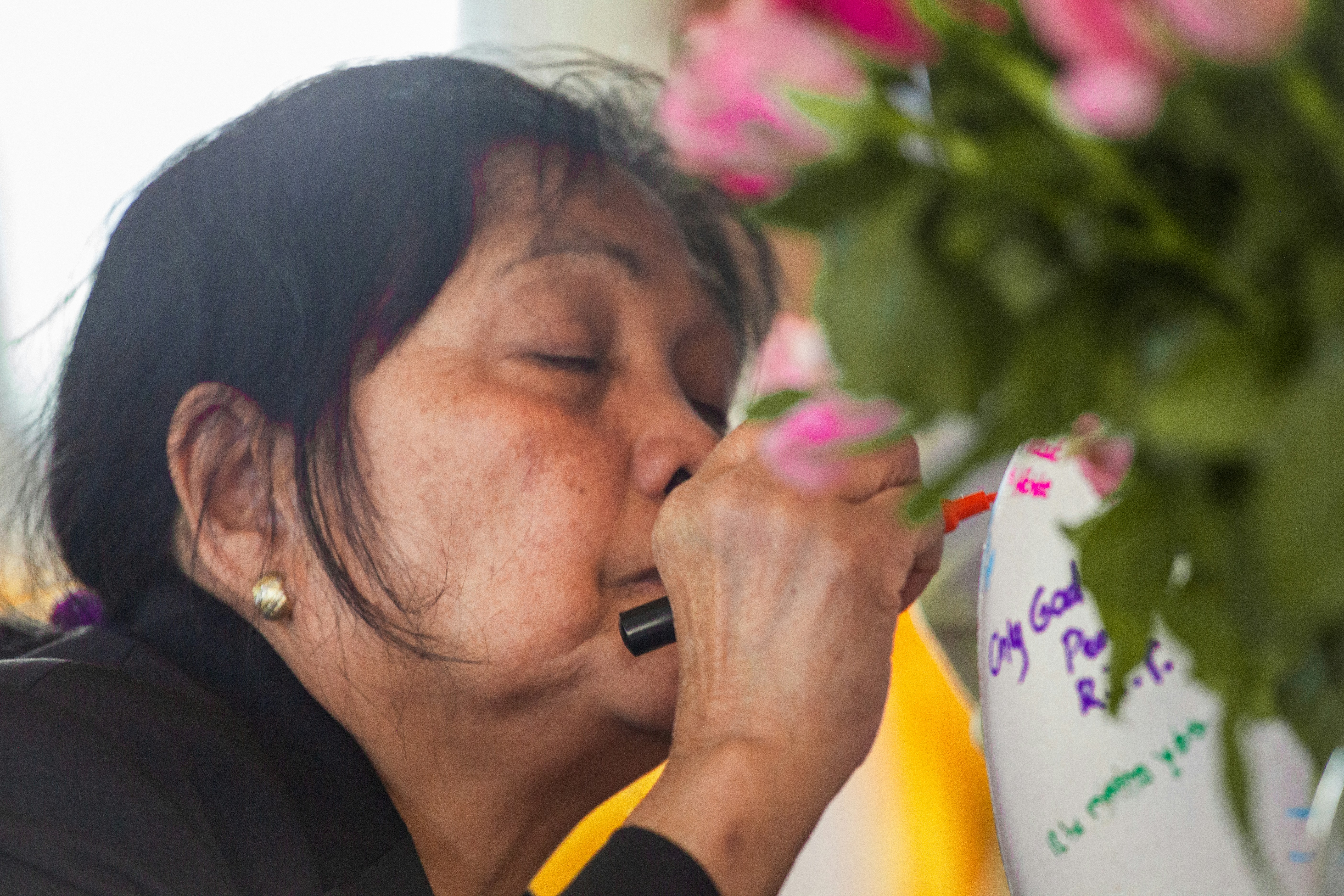 a person smelling a flower