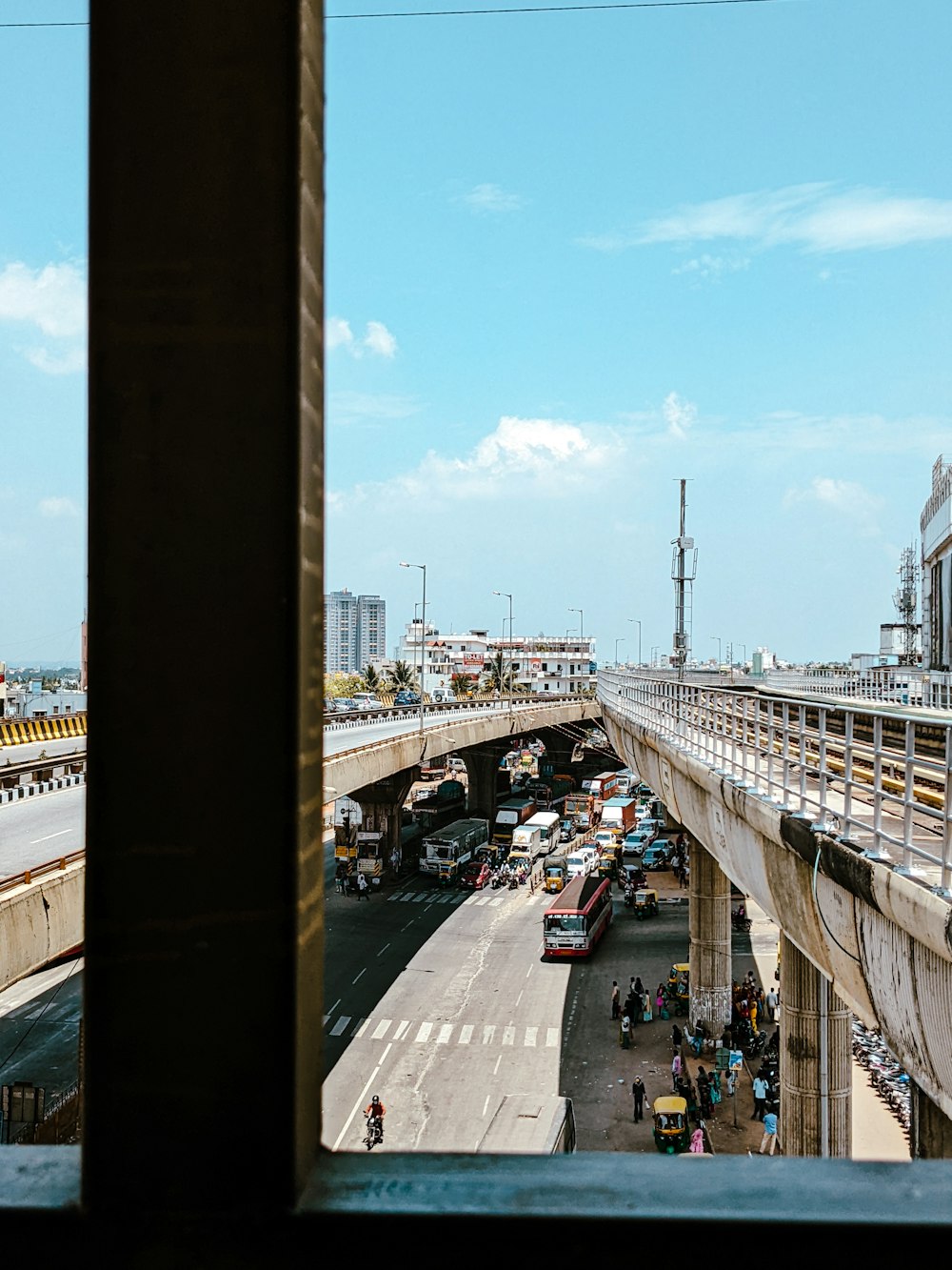 a city street with a bridge and cars