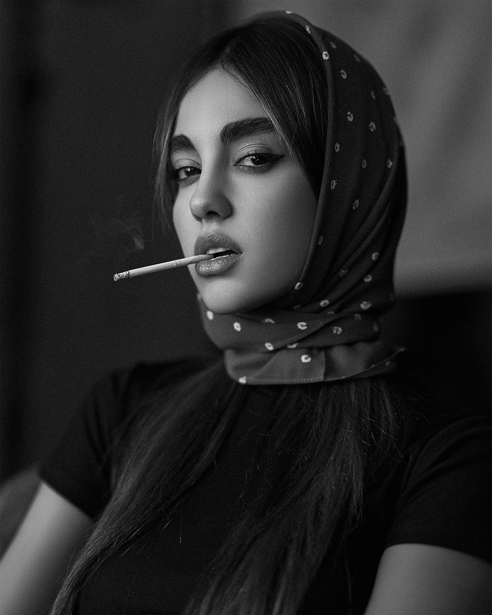 a woman with a cigarette in her mouth