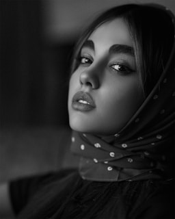 A striking black and white portrait of a person with expressive features.