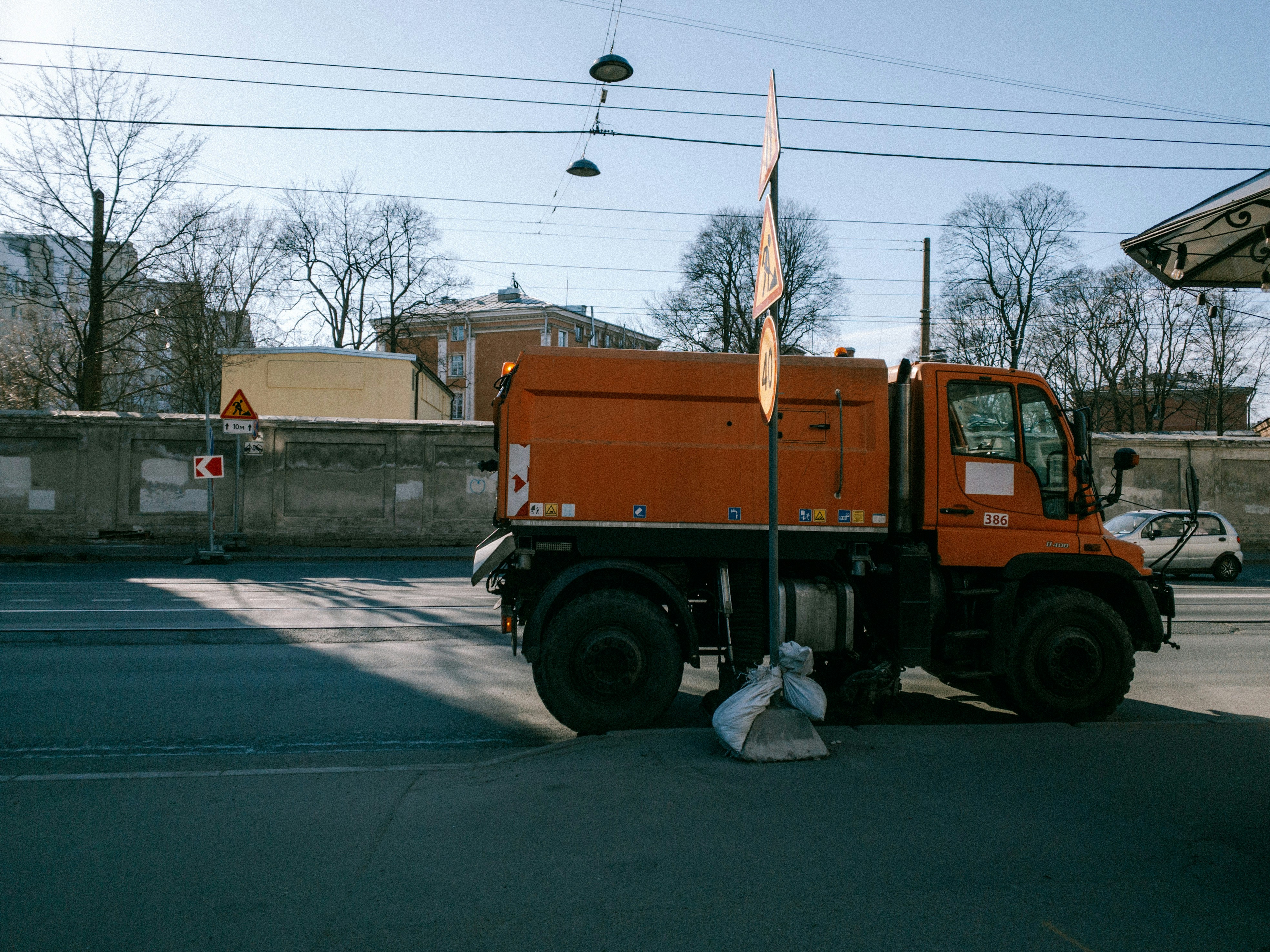 a large orange truck parked in a parking lot