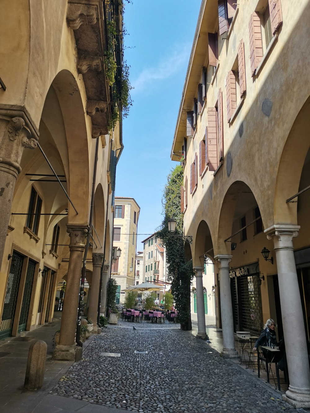 a cobblestone street between buildings