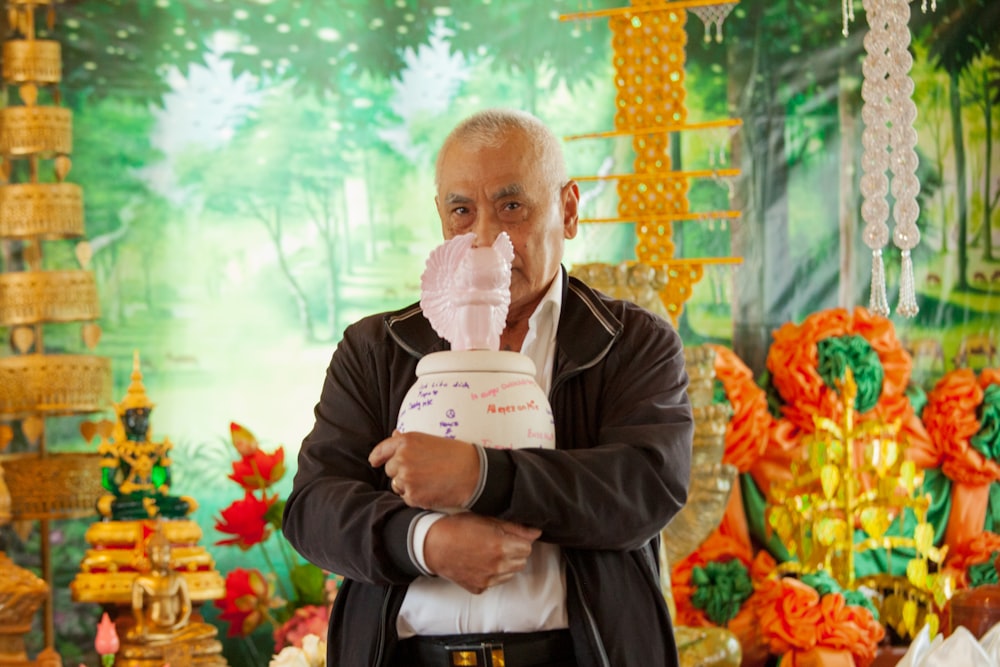 a person holding a paper and a bouquet of flowers