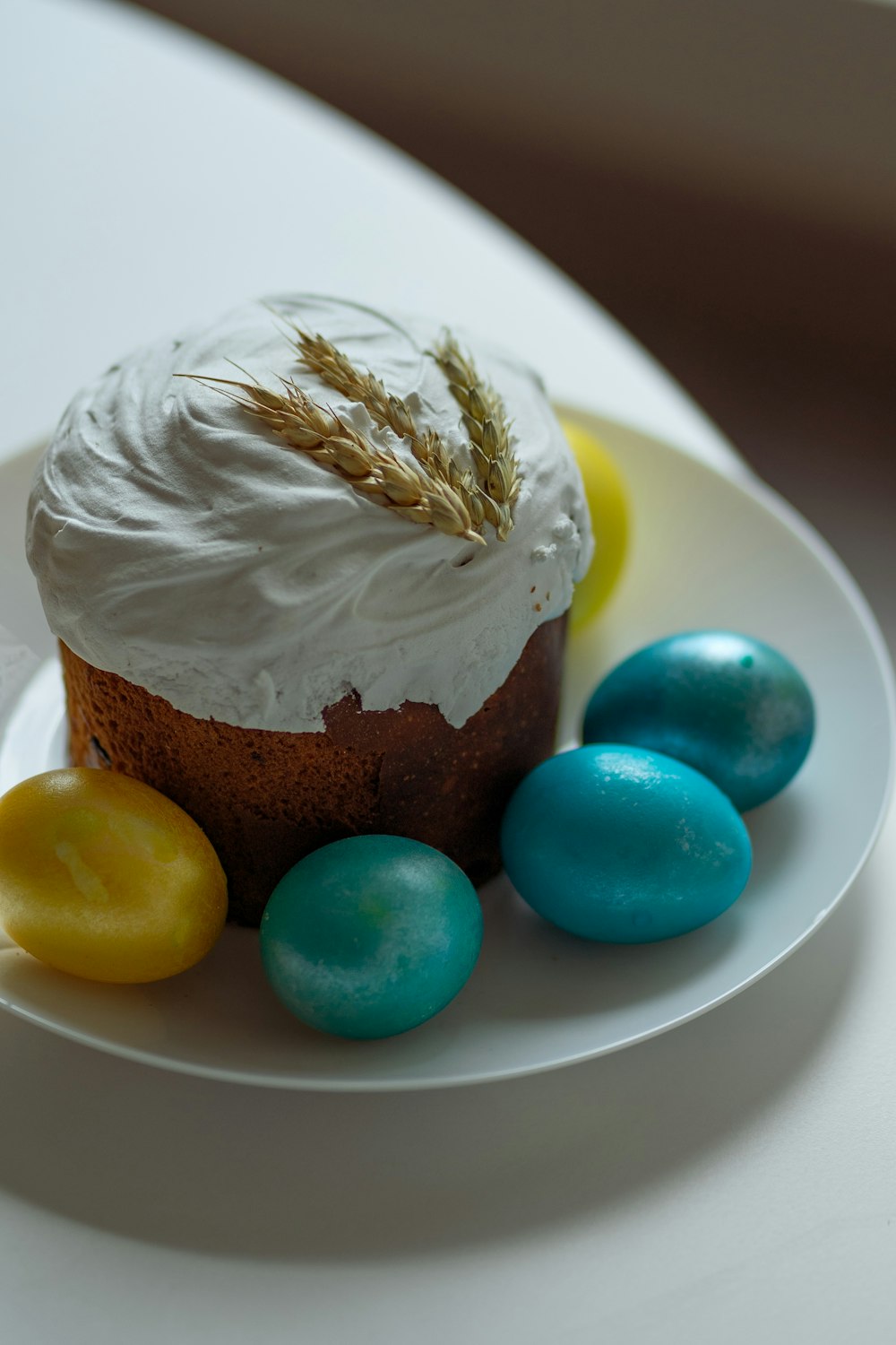 a cupcake with ice cream and candy on a plate