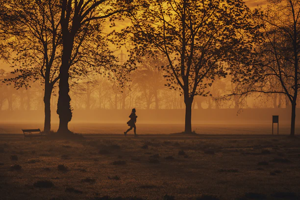 A serene early morning run along a tree-lined path in Suffolk, Virginia, with soft sunlight filtering through.