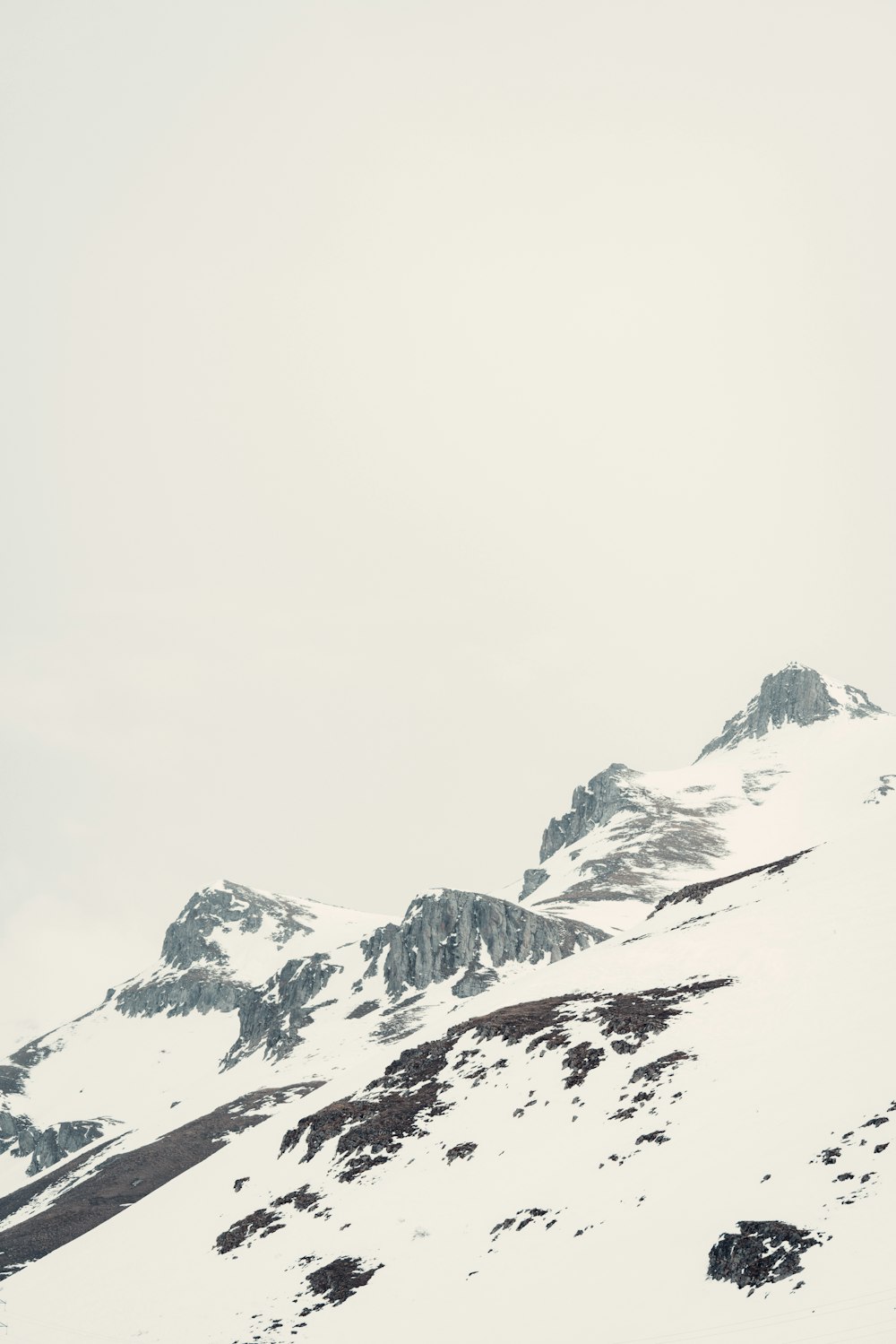 a snowy mountain with a cloudy sky