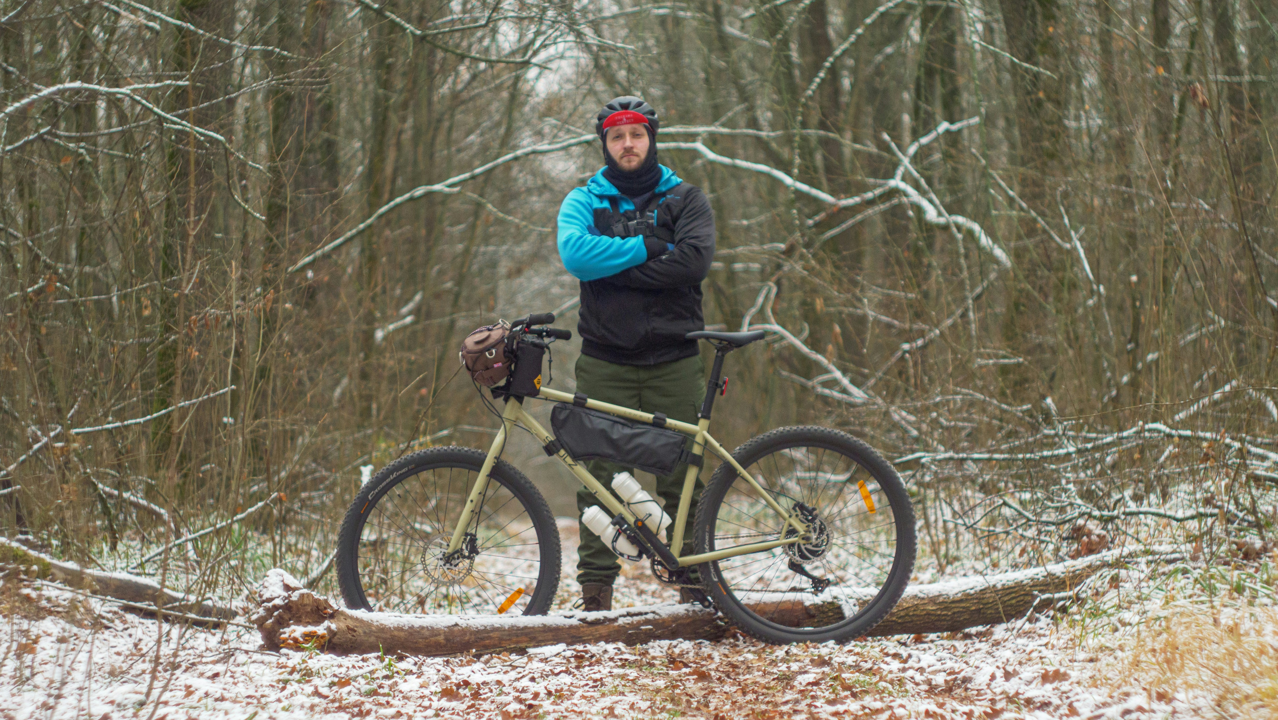 a man standing next to a bicycle