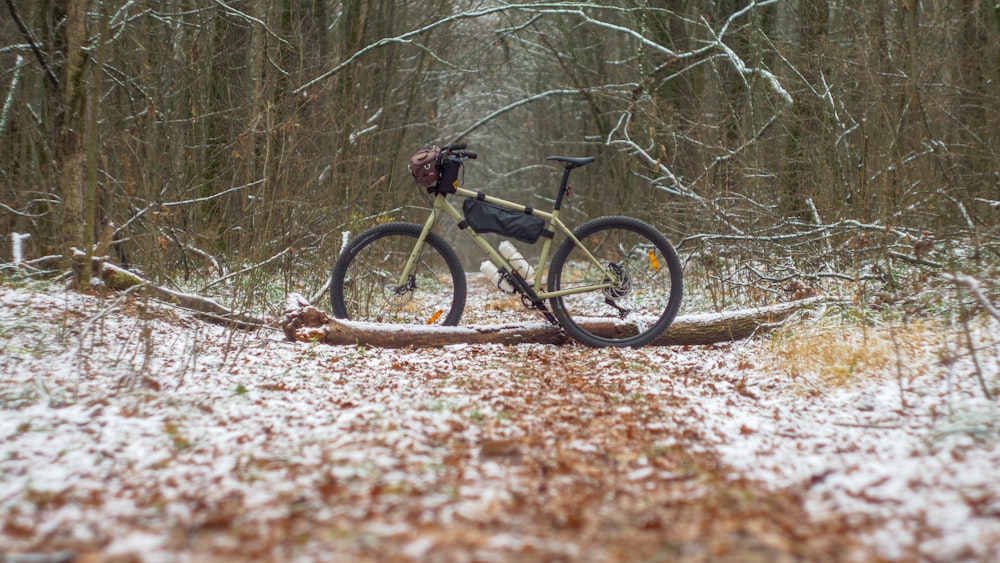 a bicycle parked on a dirt path