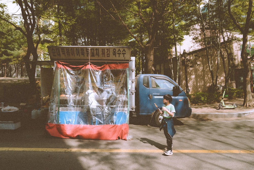 a person walking in front of a blue van