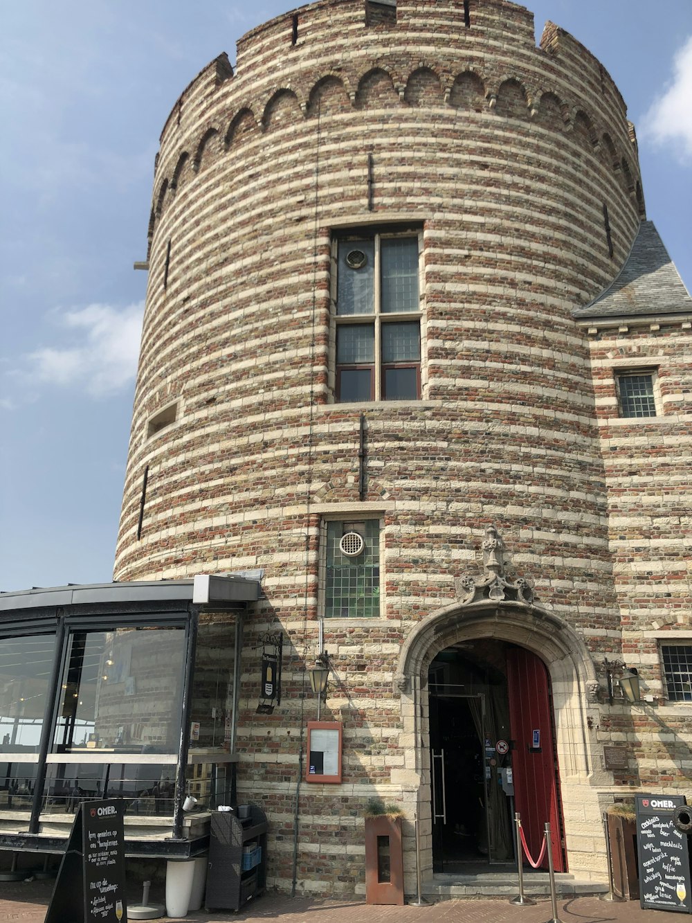 a brick building with a round tower