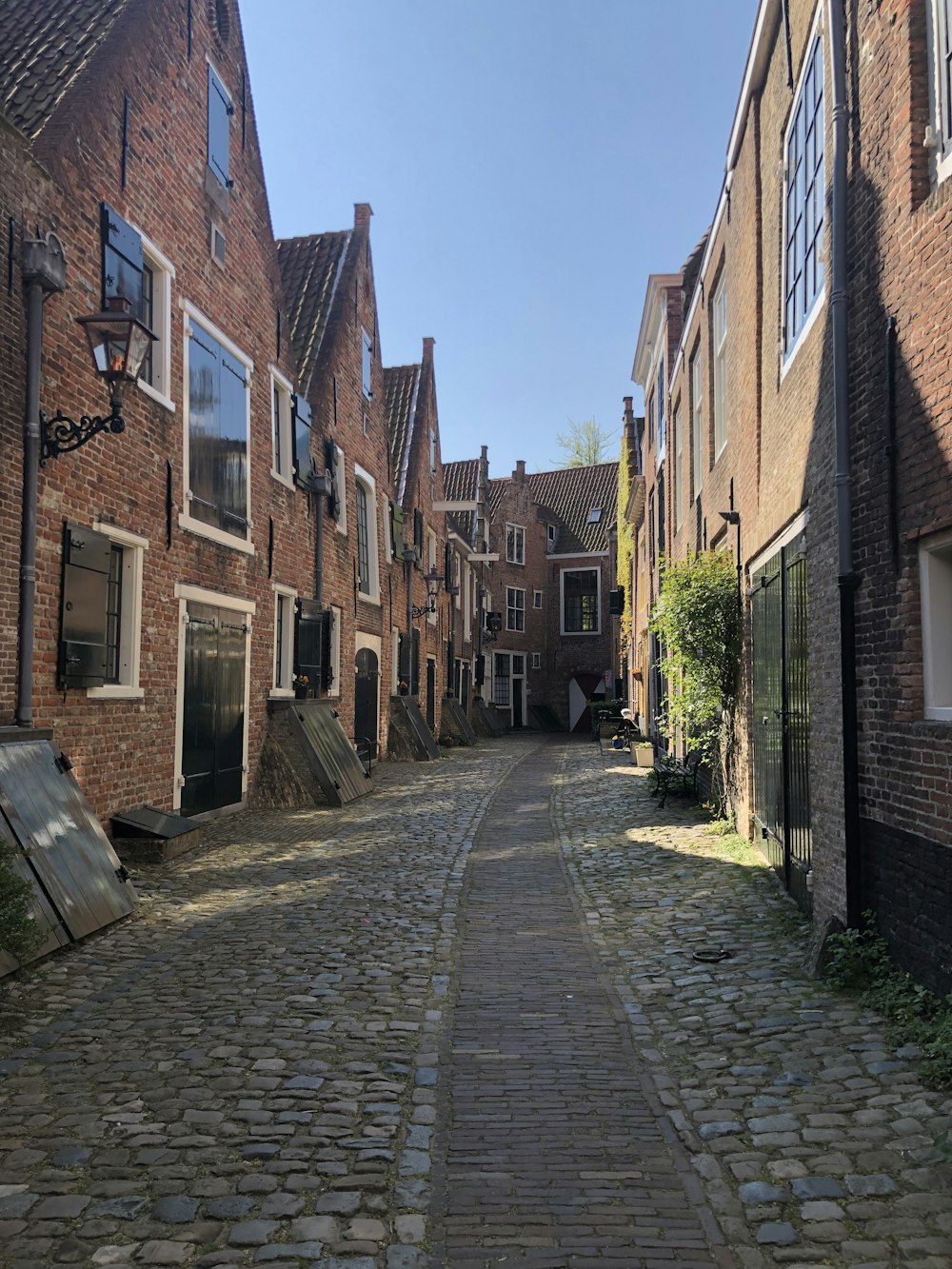 a cobblestone street between buildings