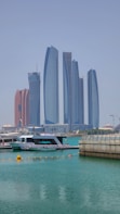 a boat in the water with tall buildings in the background