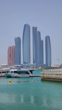 a boat in the water with tall buildings in the background