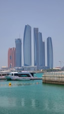 a boat in the water with tall buildings in the background