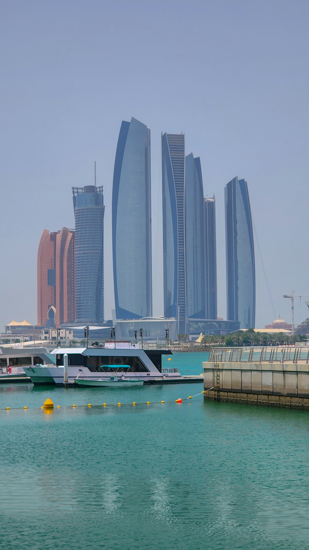 a boat in the water with tall buildings in the background