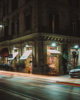A dimly lit Parisian street at night, with subtle neon signs hinting at secret rendezvous spots.