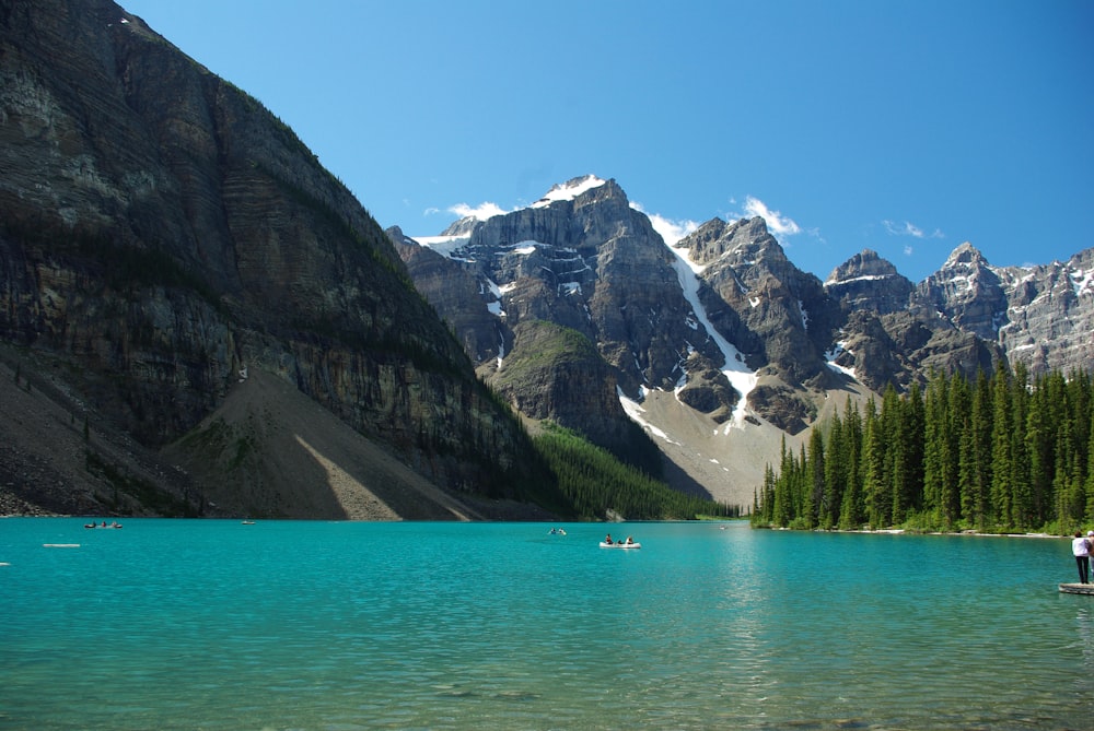 a body of water with mountains in the back