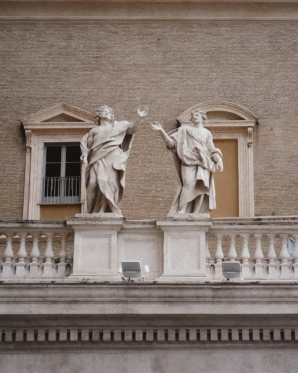 a statue of a man and a woman on a building