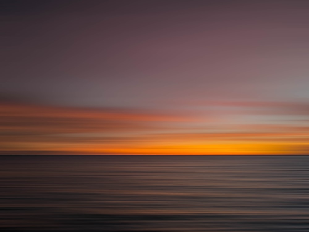 a sunset over a large body of water