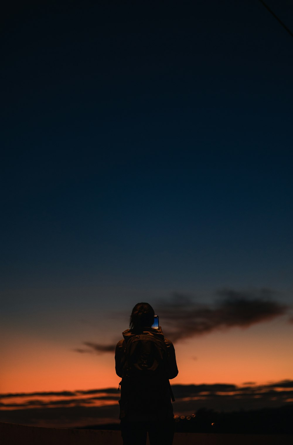 a person standing in front of a sunset