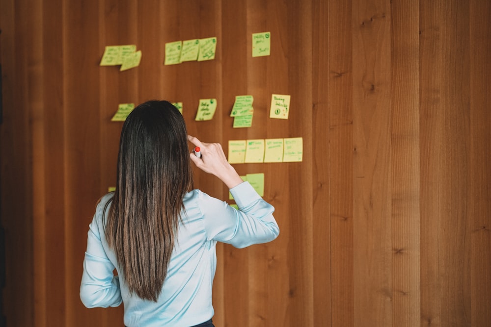 a person writing on a board