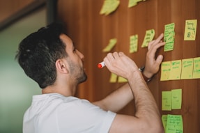 a man holding a yellow marker