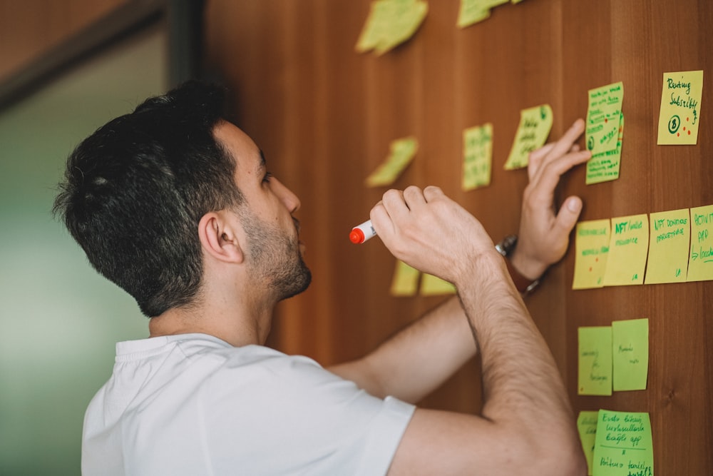 a man holding a yellow marker