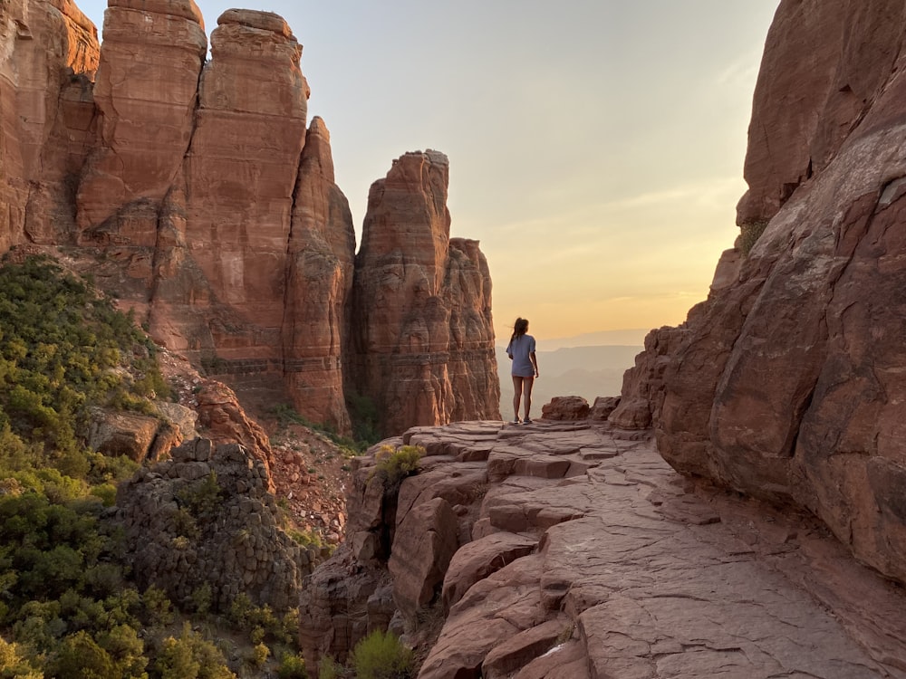 a person standing on a rock ledge