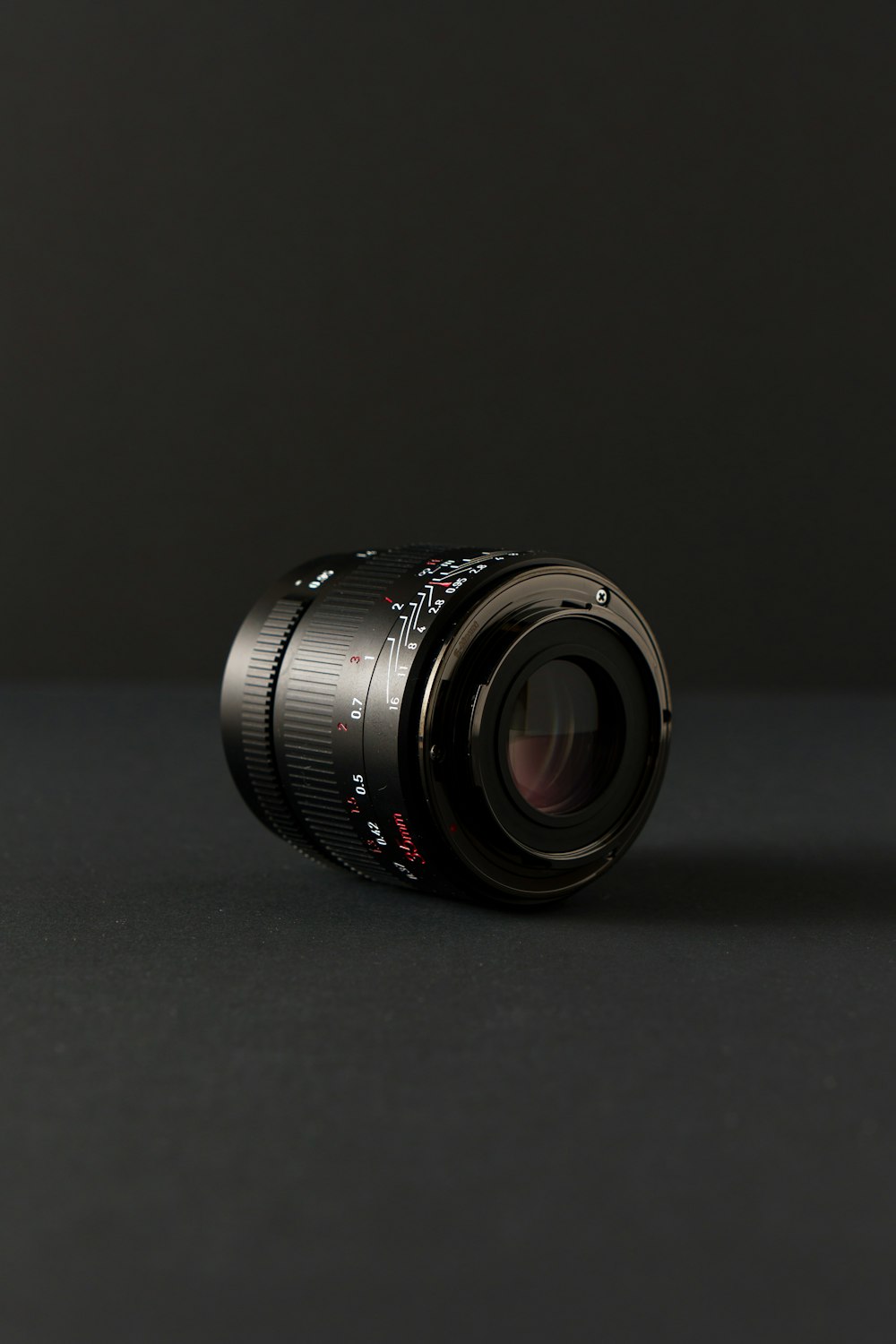 a camera lens on a black surface