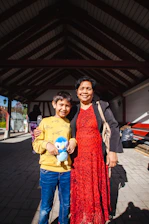A smiling child holding a colorful toy donated by the community.
