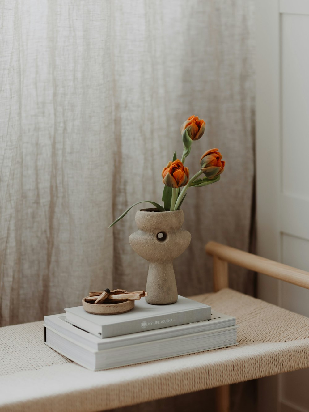 a vase with flowers on a table