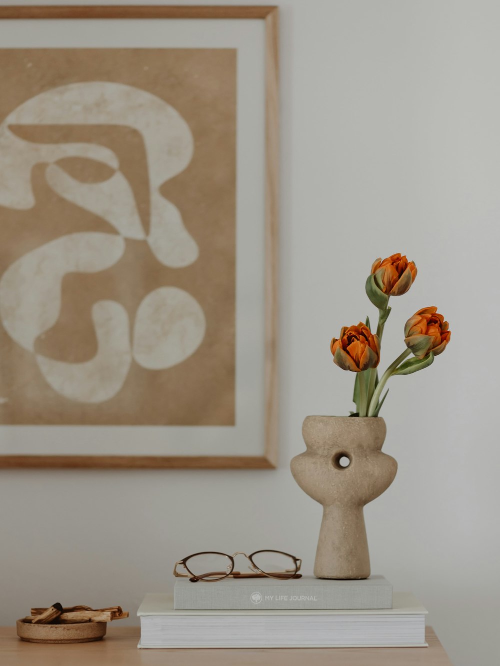 a vase with flowers on a table