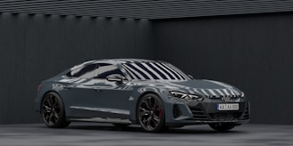 A sleek steel-gray car with OEM parts being installed by a professional mechanic.