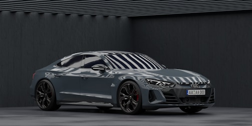 A sleek steel-gray car with OEM parts being installed by a professional mechanic.