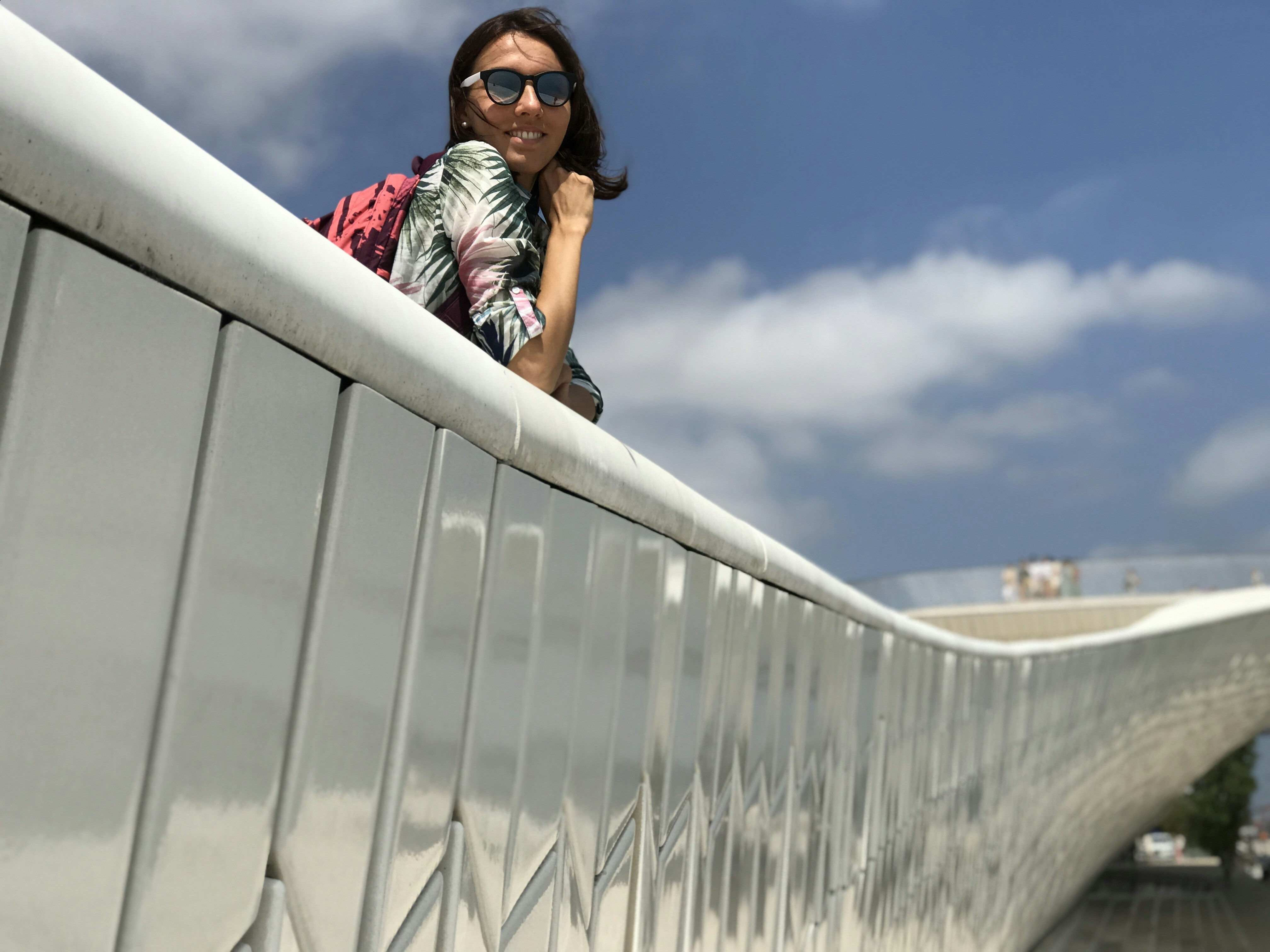 a person leaning on a large white building
