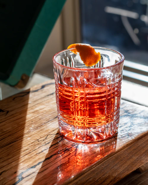 Close-up of a sleek Twistara tumbler with a vibrant swirl design on a wooden table.
