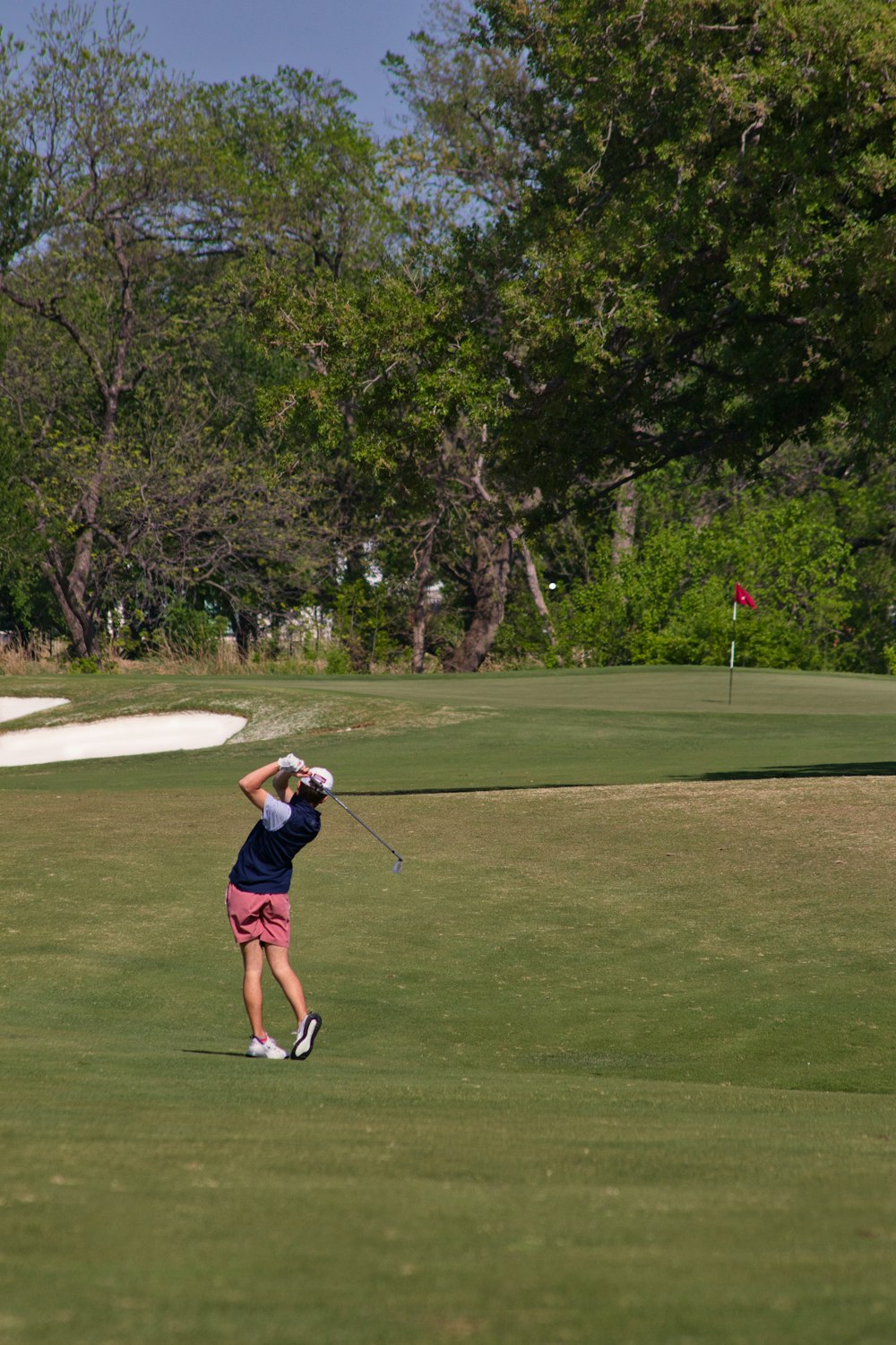 a person swinging a golf club