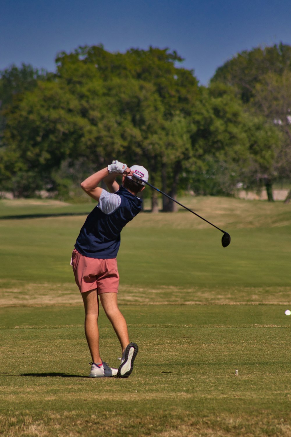 a person swinging a golf club