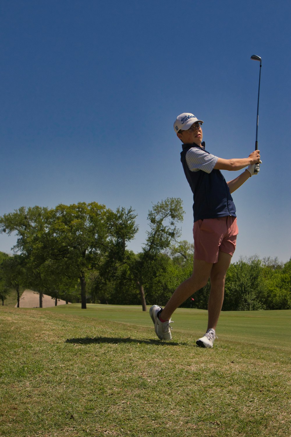 a person swinging a golf club