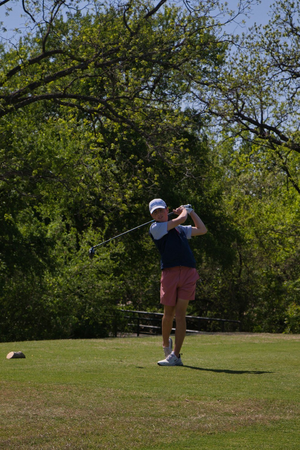 a person swinging a golf club