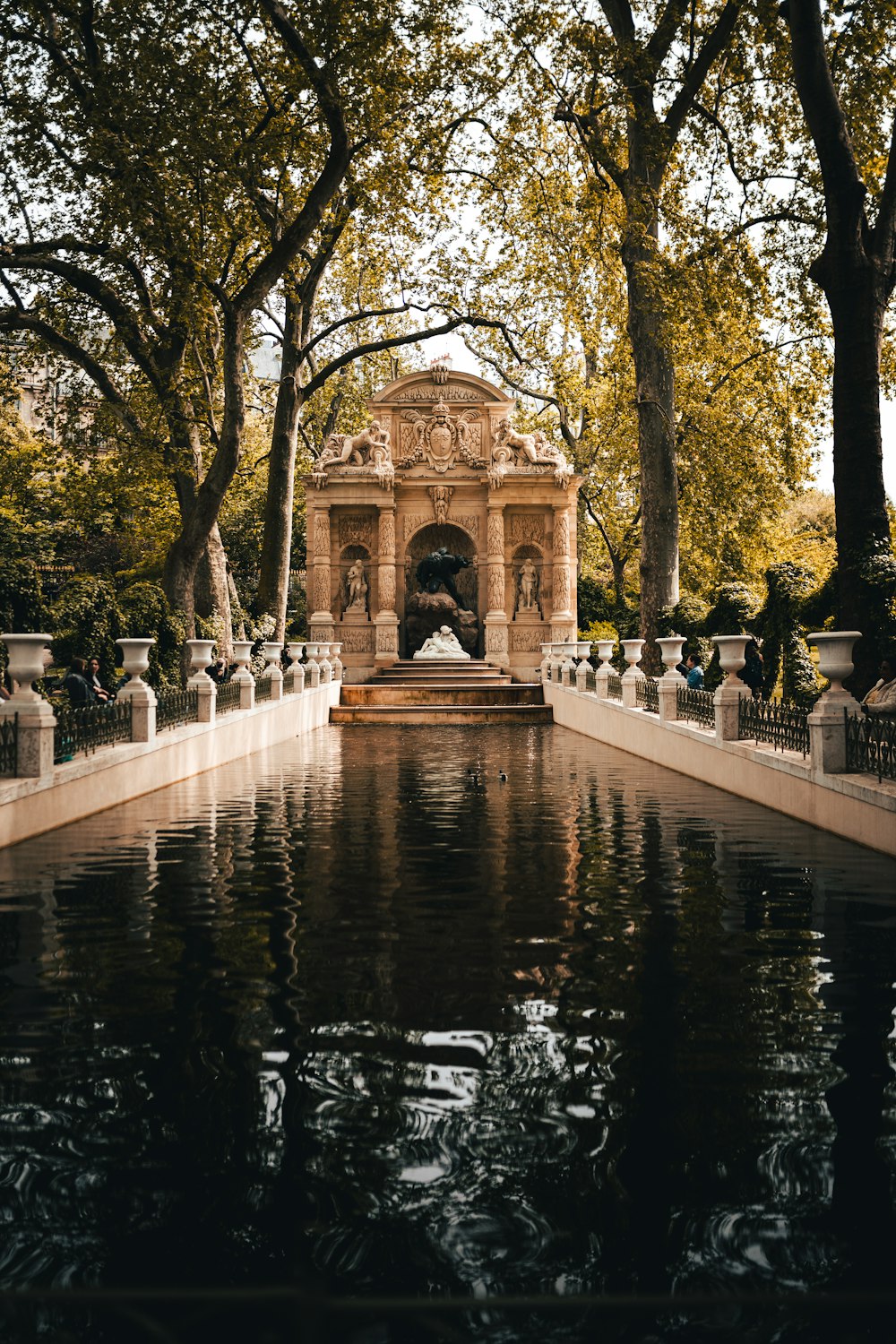 a pond with a building in the background