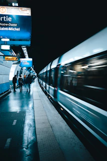 Close-up of a Line 13 metro train arriving at Saint Ouen station during rush hour.
