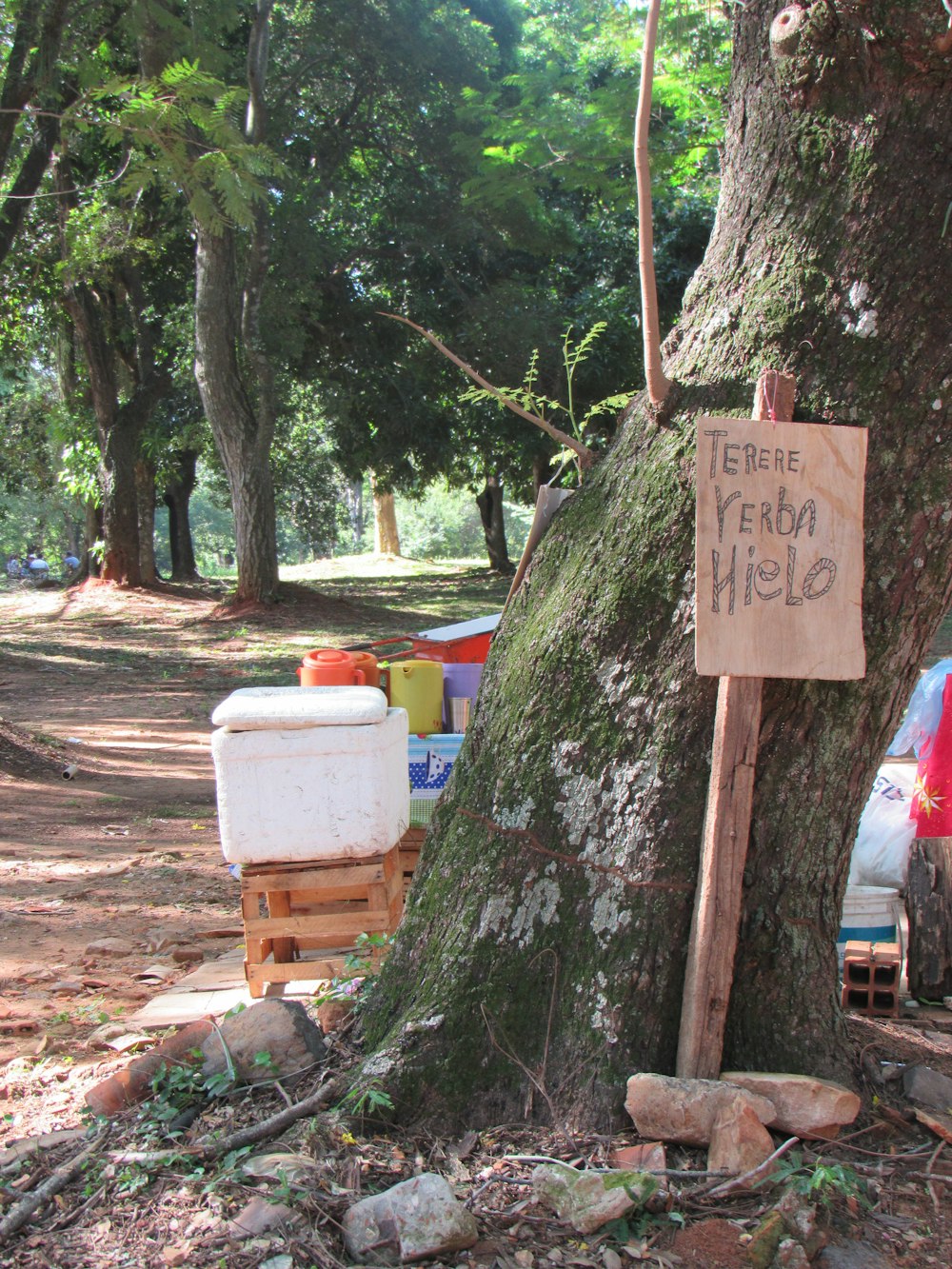 a sign next to a tree