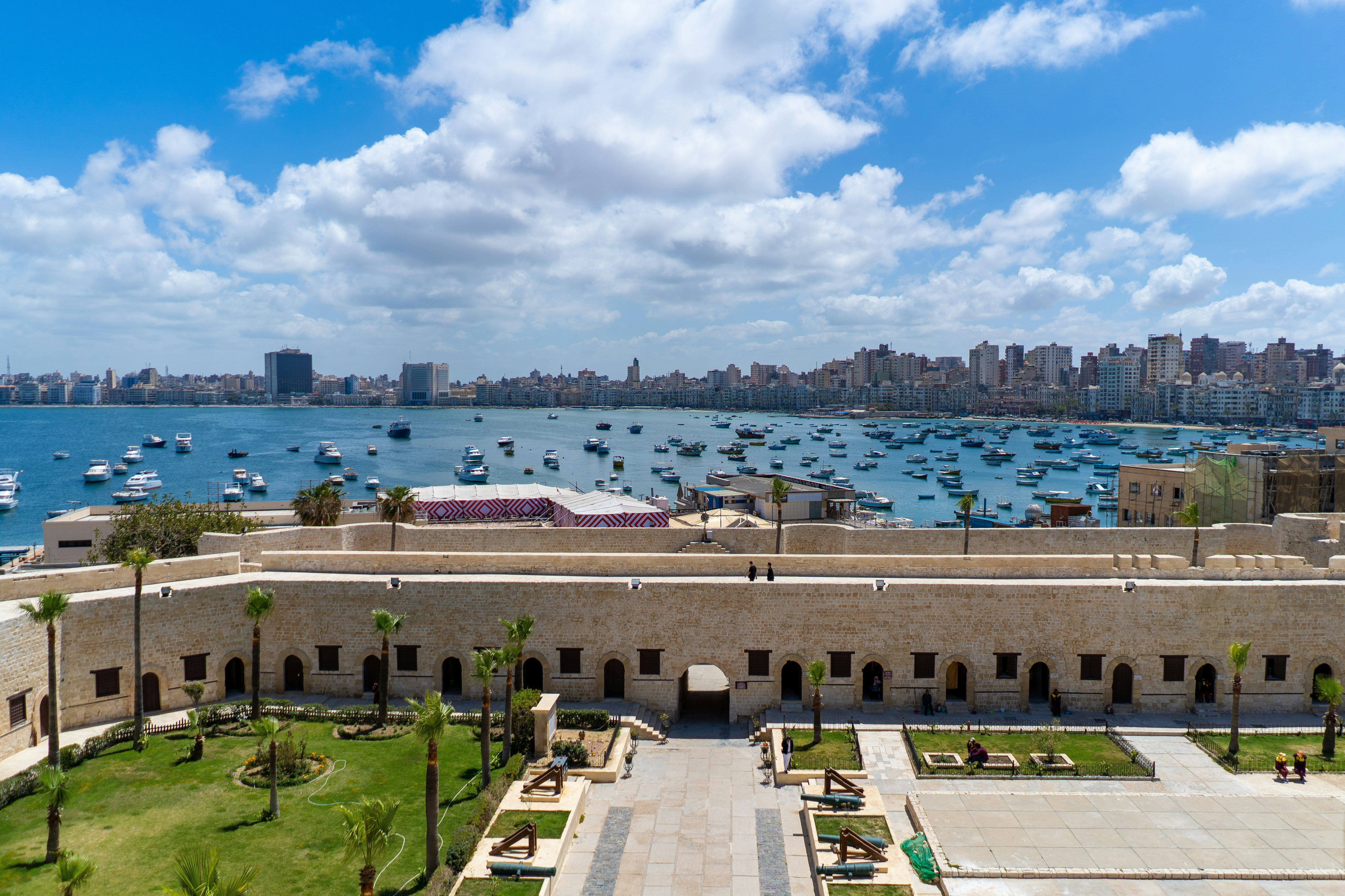 a large building with a body of water in the background