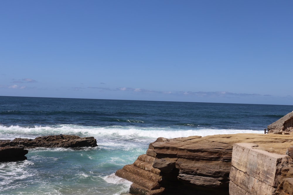 a rocky beach with waves crashing