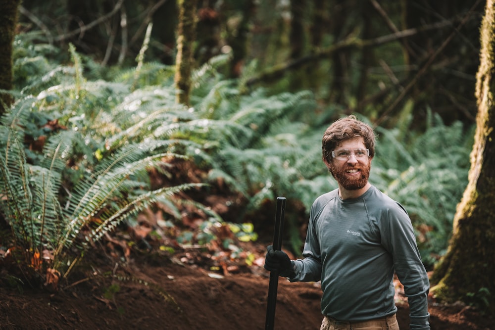 a man holding a gun in the woods