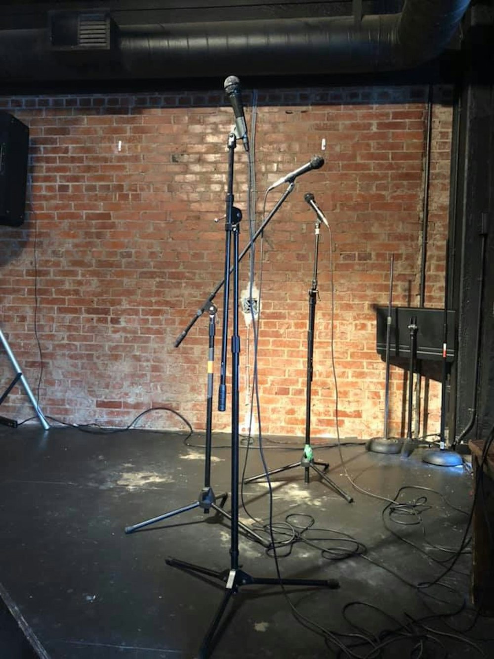 a set of microphones in front of a brick wall